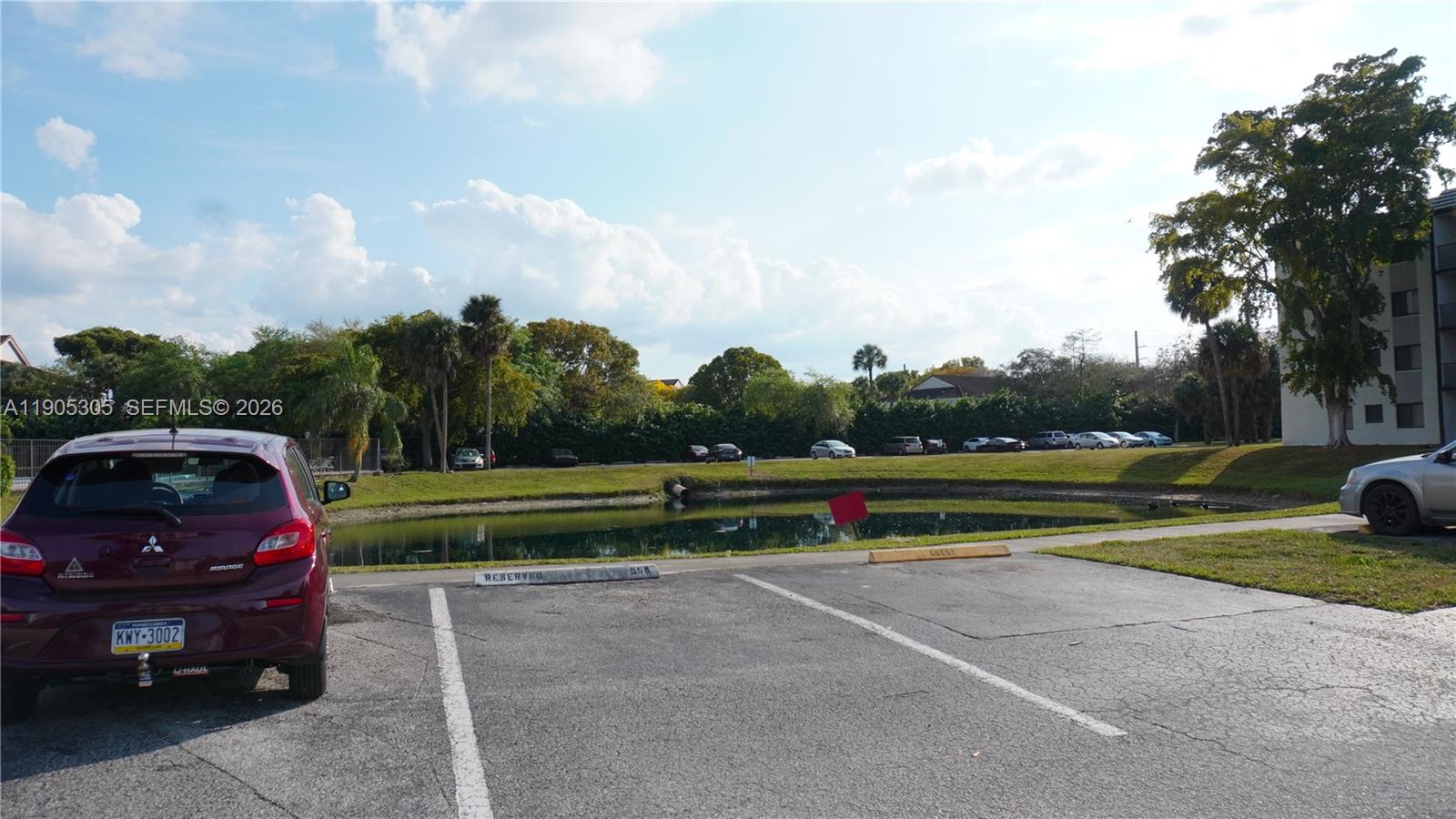 3710 North Pine Island Road, Unit 320 Sunrise, FL 33351 - Photo 14 of 14 a view of a yard with swimming pool and trees in the background