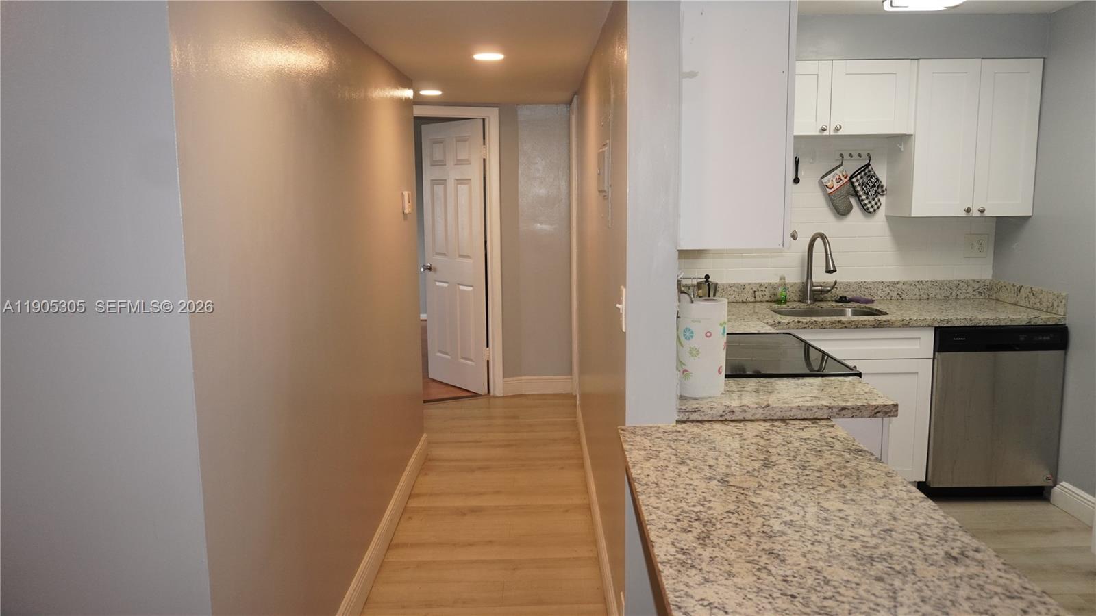 3710 North Pine Island Road, Unit 320 Sunrise, FL 33351 - Photo 3 of 14 a kitchen with kitchen island sink stove and refrigerator