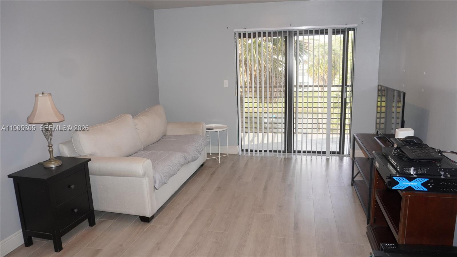 3710 North Pine Island Road, Unit 320 Sunrise, FL 33351 - Photo 4 of 14 a living room with furniture and a window