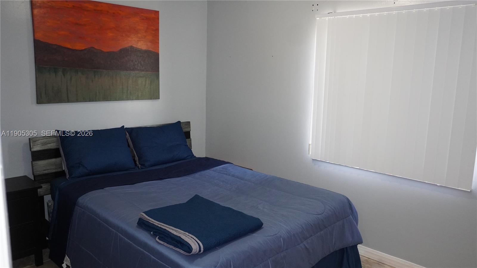 3710 North Pine Island Road, Unit 320 Sunrise, FL 33351 - Photo 7 of 14 a bed sitting in a bedroom next to a window