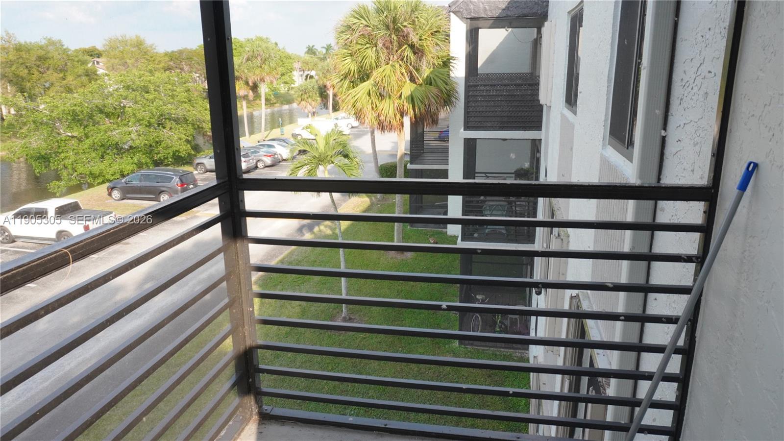 3710 North Pine Island Road, Unit 320 Sunrise, FL 33351 - Photo 9 of 14 a view of a balcony with a lake view