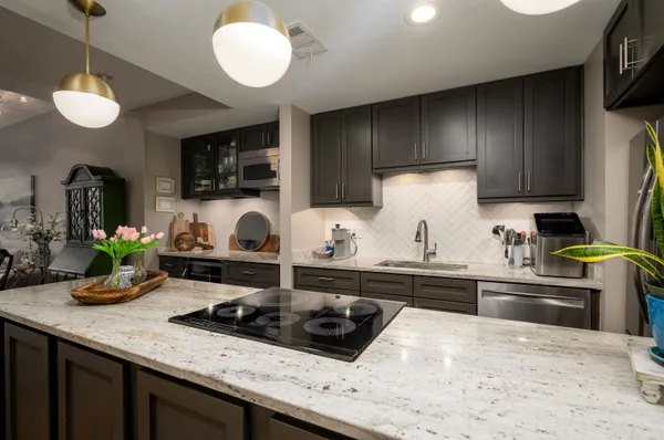 a kitchen with a stove a sink and a refrigerator
