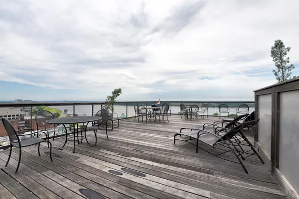 a view of a balcony with furniture and wooden floor