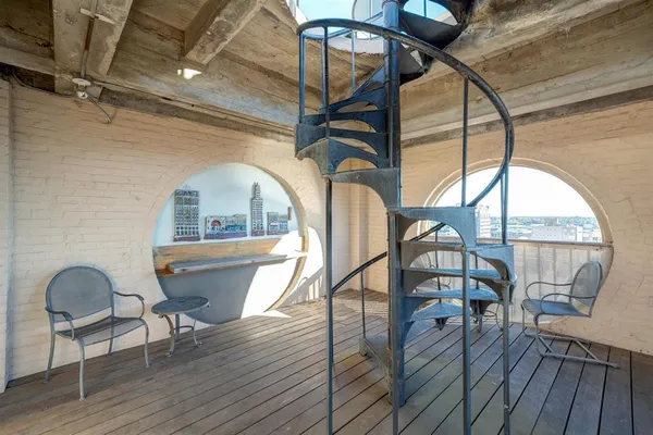 a view of a chairs and a table in the balcony