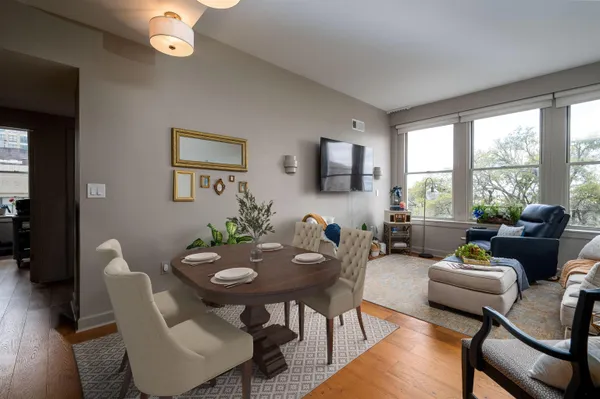 a view of a dining room with furniture and a large window