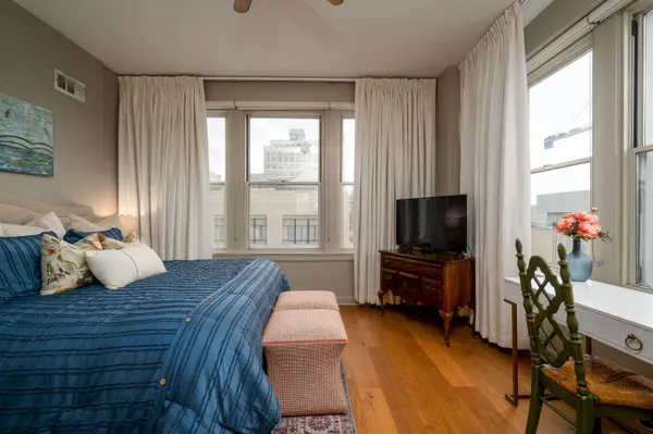 a bedroom with furniture and a flat screen tv