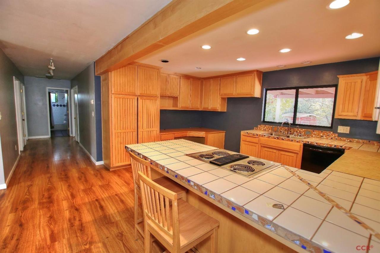 12275 Alondra Road Atascadero, CA 93422 - Photo 6 of 25 a kitchen that has a sink and a stove