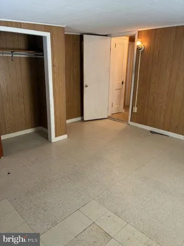 a view of a roof deck with chair and wooden floor