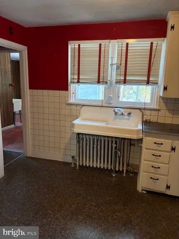 a view of a livingroom with wooden floor and a sink