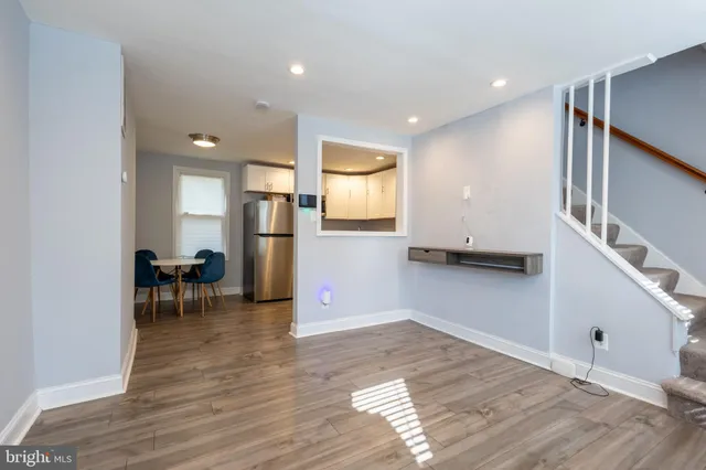 a view of a kitchen with furniture and a refrigerator
