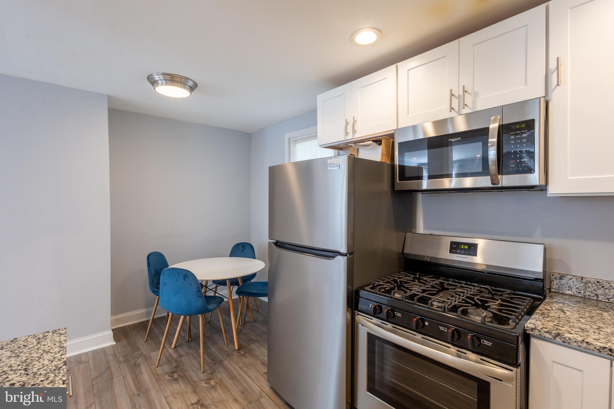 5532 B Street Southeast Washington, DC 20019 - Photo 16 of 19 a kitchen with stainless steel appliances granite countertop a stove a refrigerator and a microwave