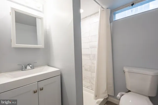 a bathroom with a sink toilet and vanity