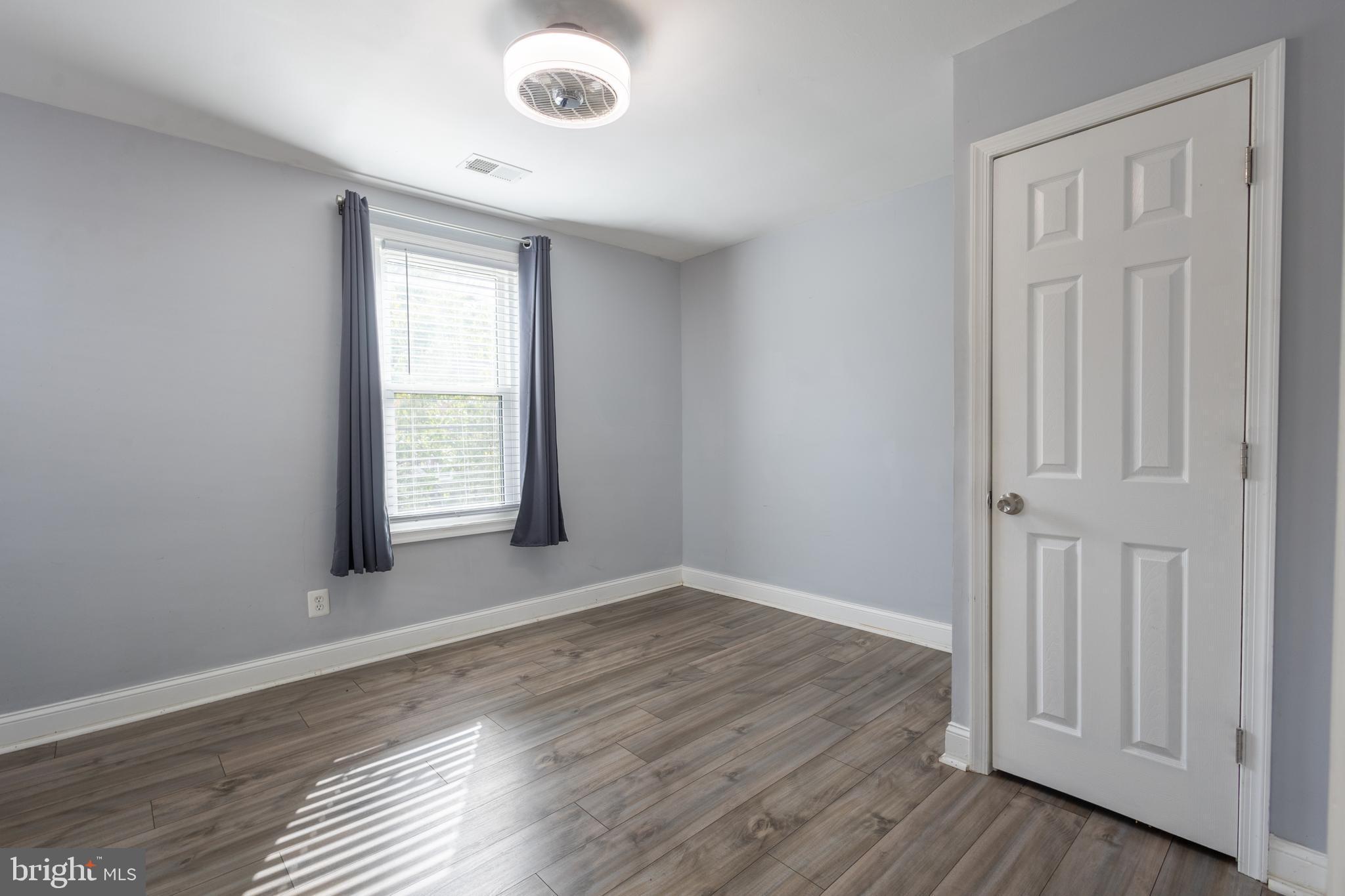 5532 B Street Southeast Washington, DC 20019 - Photo 3 of 19 an empty room with wooden floor and windows