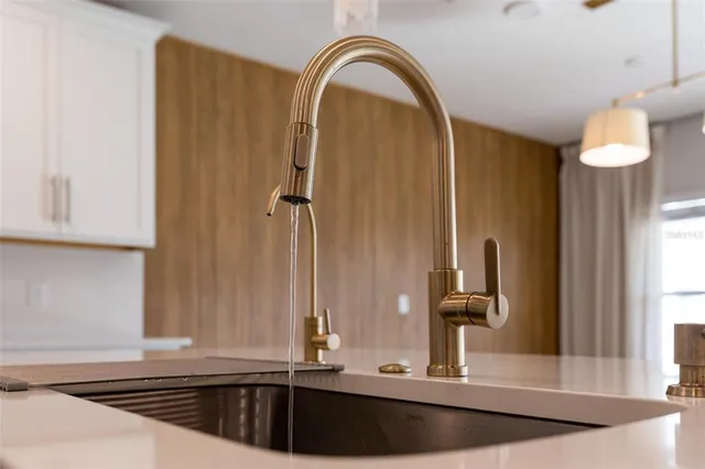 a bathroom with a granite countertop sink a toilet and a mirror