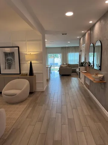 an aerial view of residential houses with outdoor space and parking