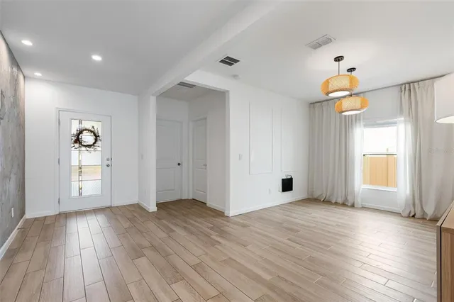 a living room with furniture and a large mirror