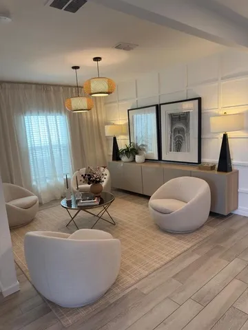 a large kitchen with stainless steel appliances granite countertop a stove a sink dishwasher and a refrigerator with wooden floor