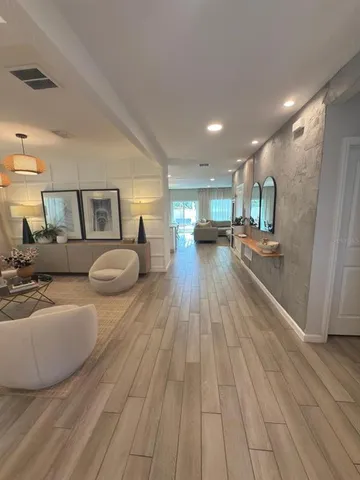 a view of staircase with white walls and white door