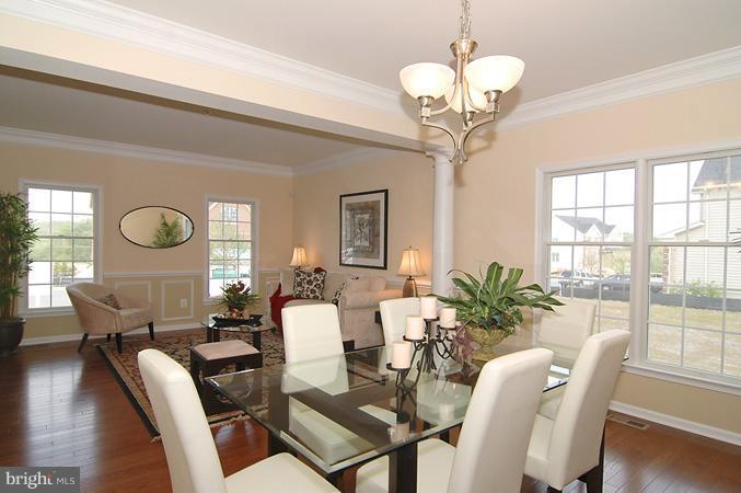 11103 Rodeo Court Upper Marlboro, MD 20772 - Photo 5 of 15 a view of a dining room with furniture a chandelier and wooden floor