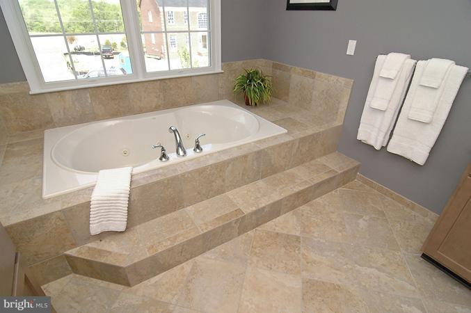 11103 Rodeo Court Upper Marlboro, MD 20772 - Photo 10 of 15 a bath tub sitting in a bathroom next to a window