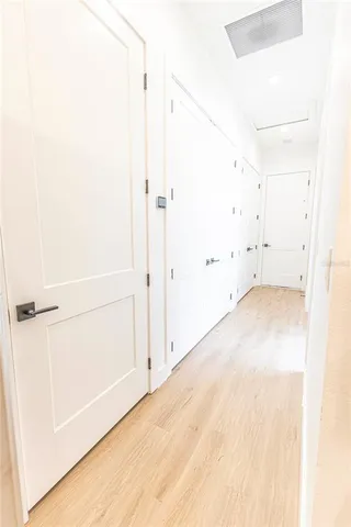a view of a hallway with wooden floor