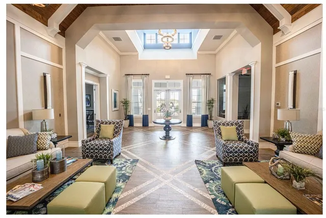 a view of a dining room with furniture a rug and wooden floor