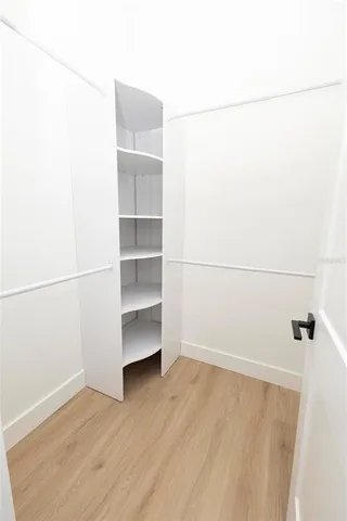 a view of a room with wooden floor