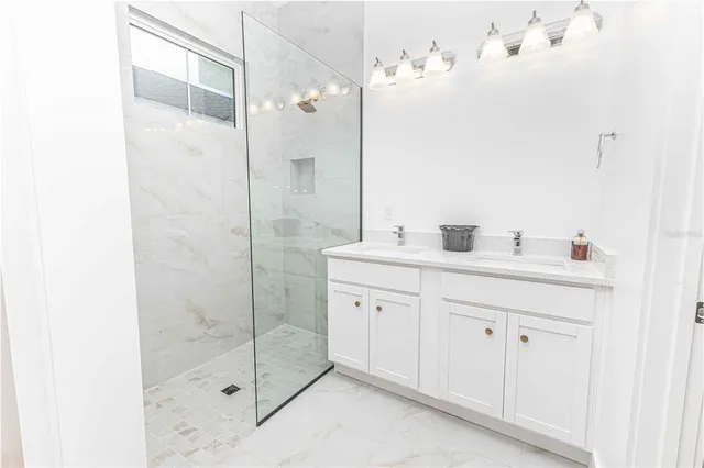 a bathroom with a shower sink and mirror