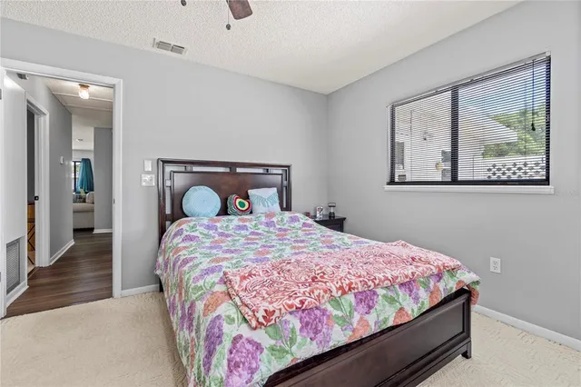 a bedroom with a bed and painting on the wall