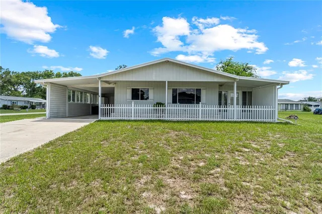 a view of a house with a backyard