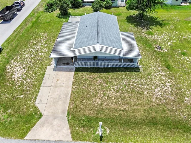 a aerial view of a house with a yard