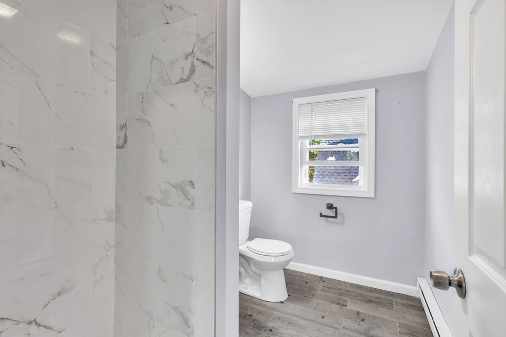 253-255 Oak Street Springfield, MA 01151 - Photo 24 of 30 a bathroom with a toilet and a shower