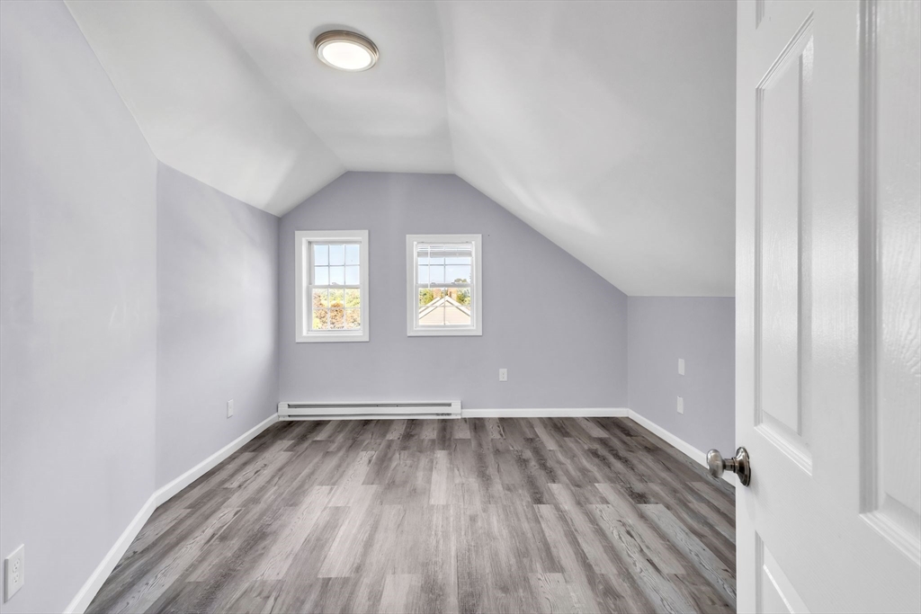 253-255 Oak Street Springfield, MA 01151 - Photo 25 of 30 an empty room with wooden floor and windows