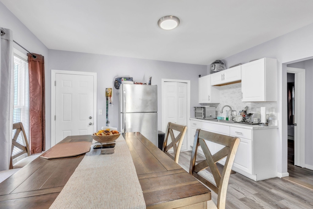 253-255 Oak Street Springfield, MA 01151 - Photo 8 of 30 a view of a kitchen with fridge and wooden floor