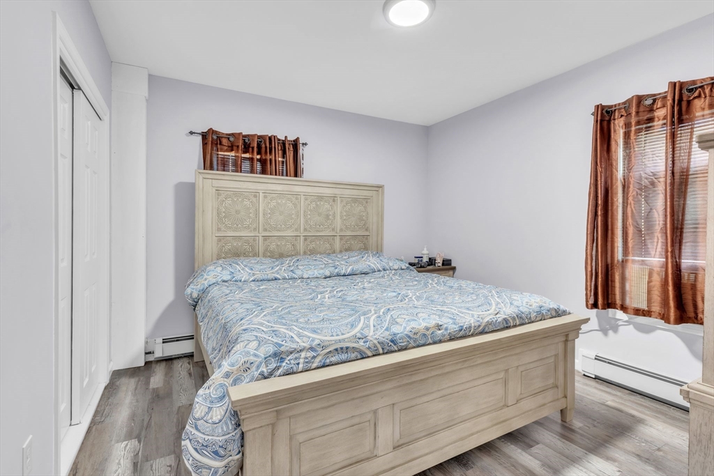 253-255 Oak Street Springfield, MA 01151 - Photo 10 of 30 a bed sitting in a bedroom next to a window