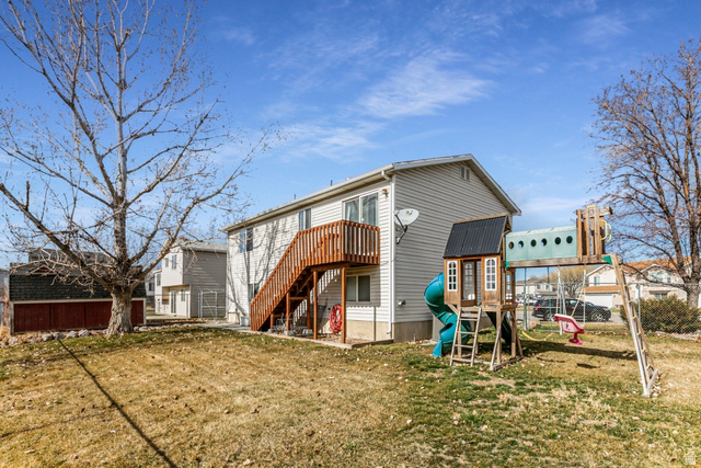 4239 West 5325th Street South Roy, UT 84067 - Photo 25 of 26 Rear view of property featuring stairs and a playground