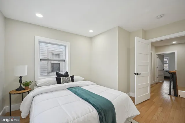 a bedroom with a bed and a potted plant