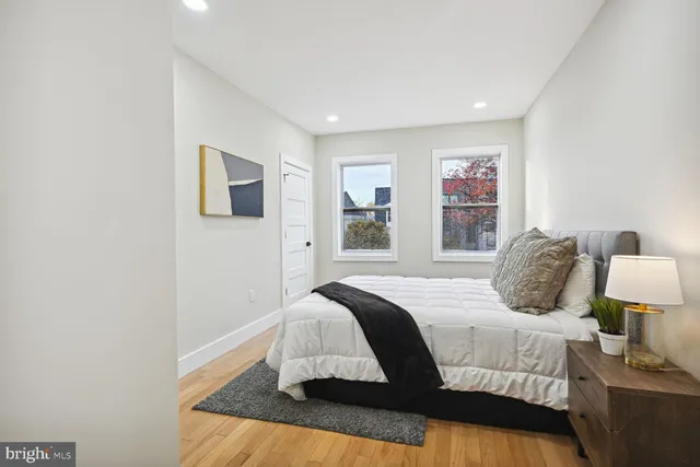 a bedroom with a large bed and a window