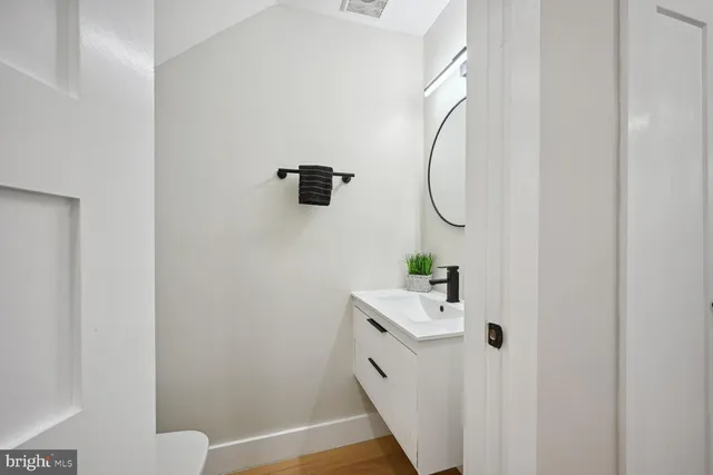 a bathroom with a sink a toilet and a mirror