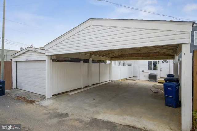 a view of a house with more windows and wooden fence