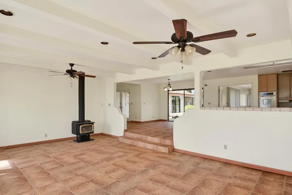 a kitchen with granite countertop a sink and white cabinets