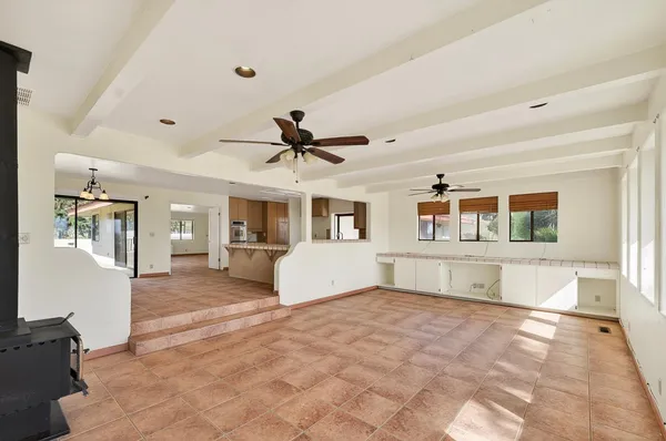 a large white kitchen with a large window