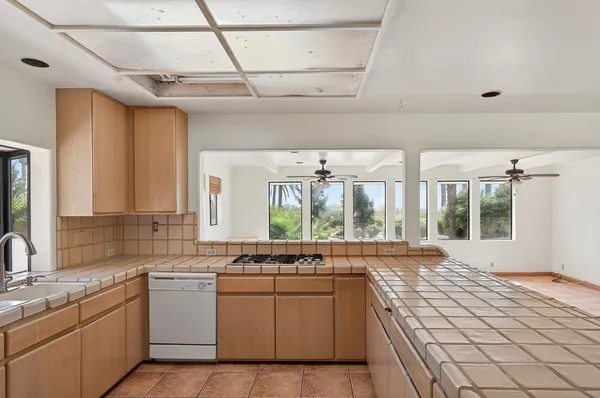 a view of an empty room with a kitchen
