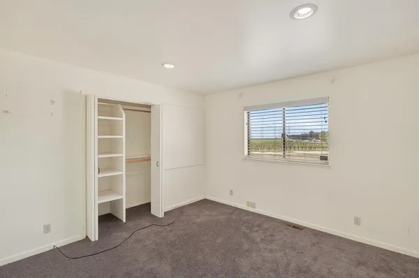 a front view of a house with a potted plants and a fountain