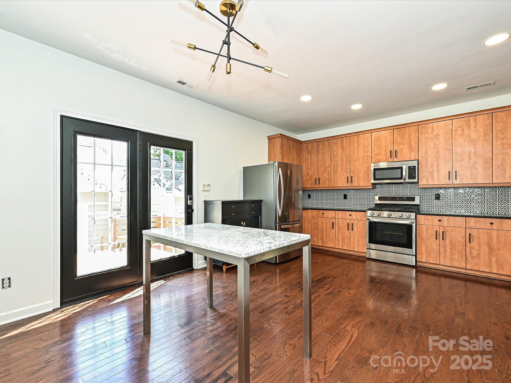 1035 Market Street Fort Mill, SC 29708 - Photo 14 of 28 a kitchen with stainless steel appliances granite countertop a stove refrigerator and a sink with granite countertops