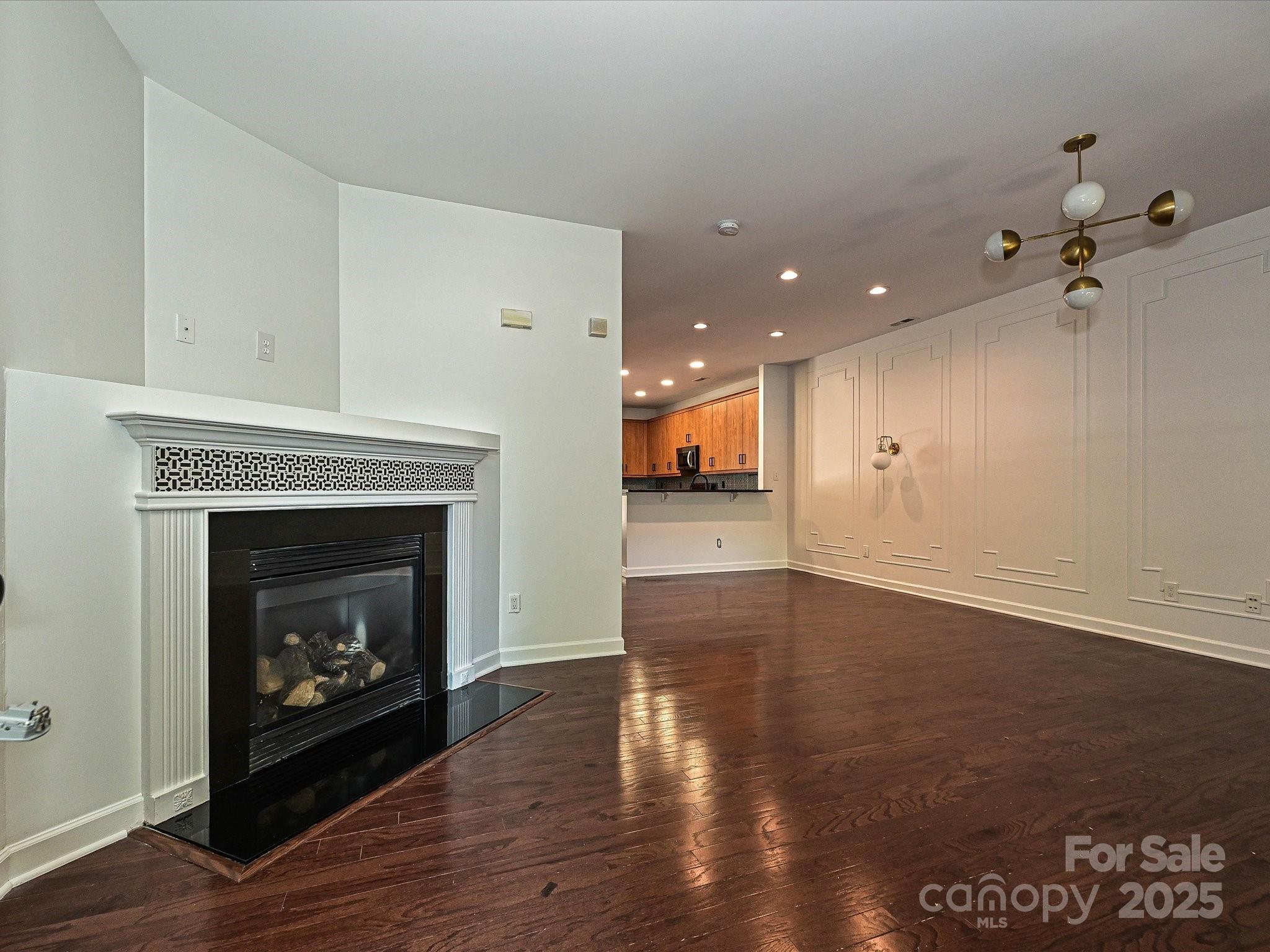 1035 Market Street Fort Mill, SC 29708 - Photo 3 of 28 a living room with a fireplace and wooden floor