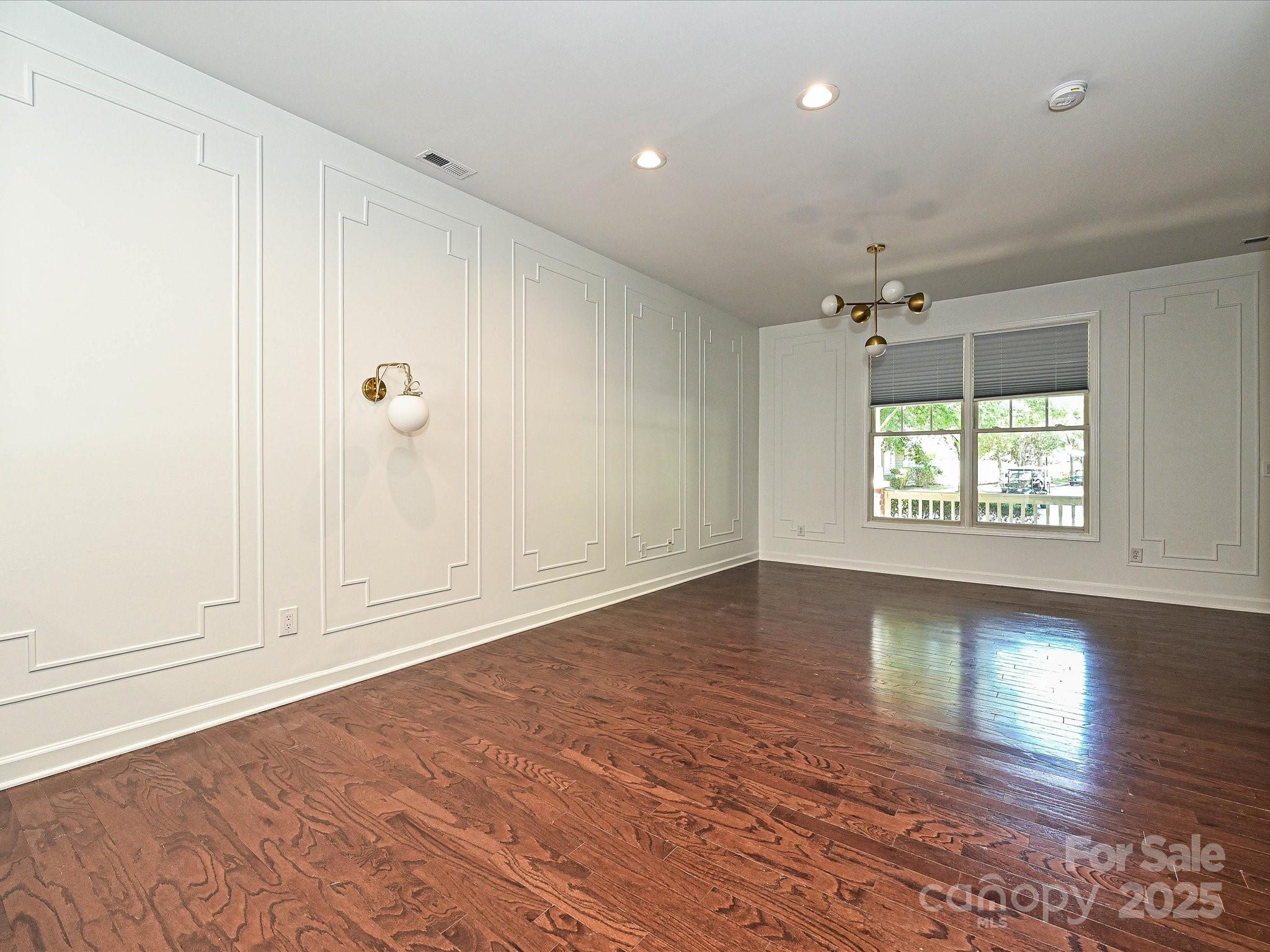 1035 Market Street Fort Mill, SC 29708 - Photo 5 of 28 an empty room with wooden floor and windows