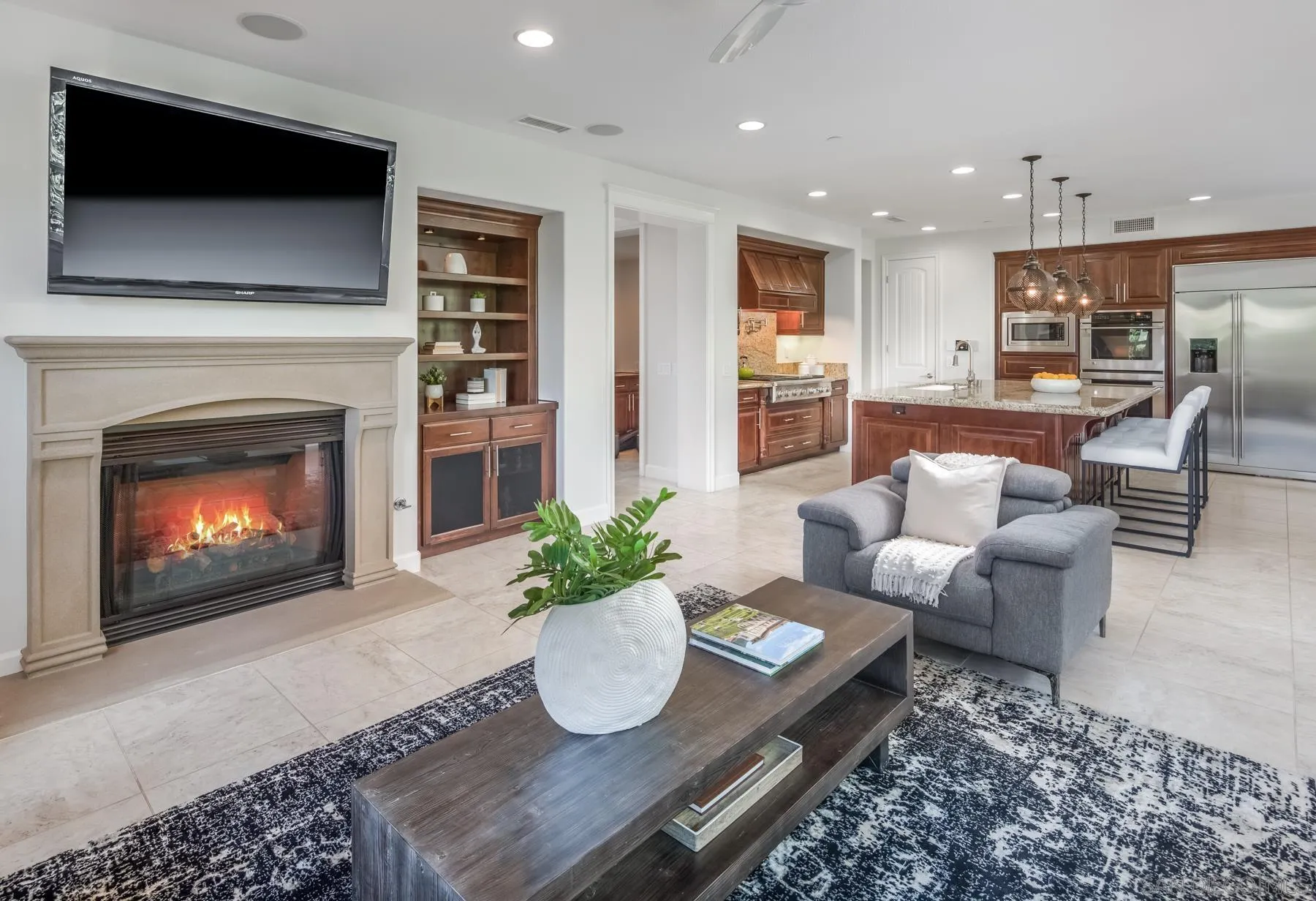 548 Quail Pointe Lane Encinitas, CA 92024 - Photo 11 of 30 a living room with furniture a fireplace and a flat screen tv