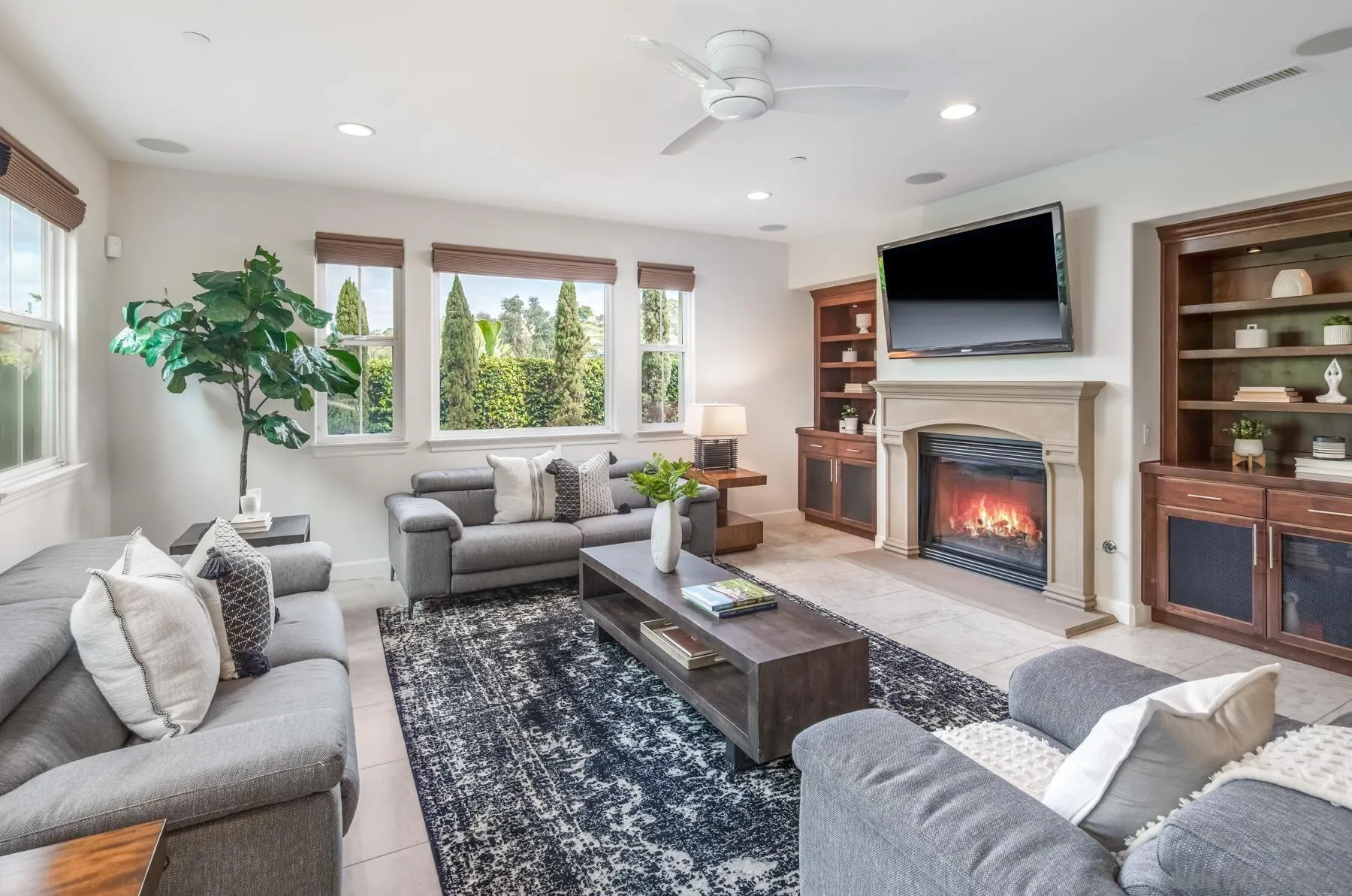 548 Quail Pointe Lane Encinitas, CA 92024 - Photo 12 of 30 a living room with furniture large window and a fireplace