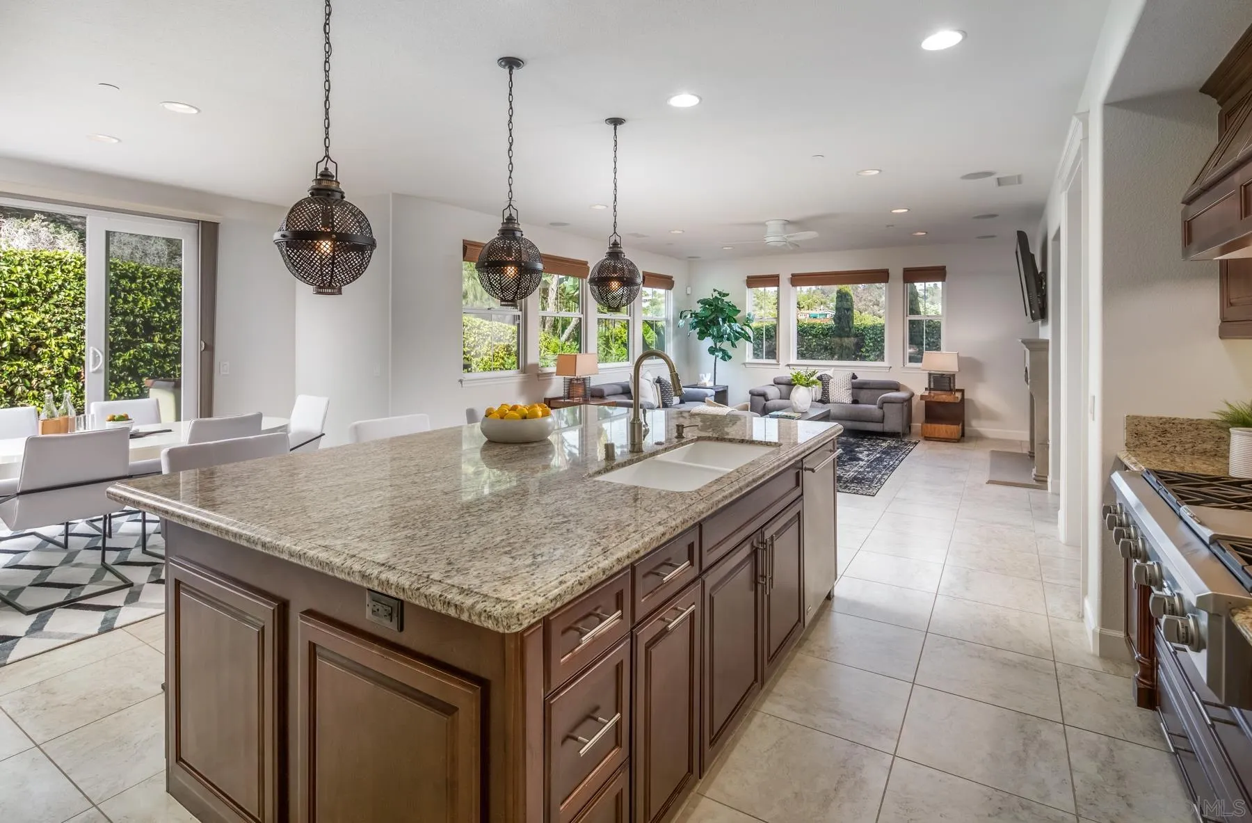 548 Quail Pointe Lane Encinitas, CA 92024 - Photo 7 of 30 a kitchen with a sink a counter top space and living room view